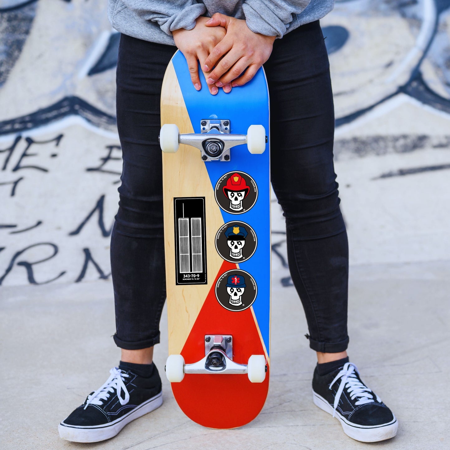 Person holding a colorful skateboard with Honor Til Ya Die and Remember Til Ya Die stickers