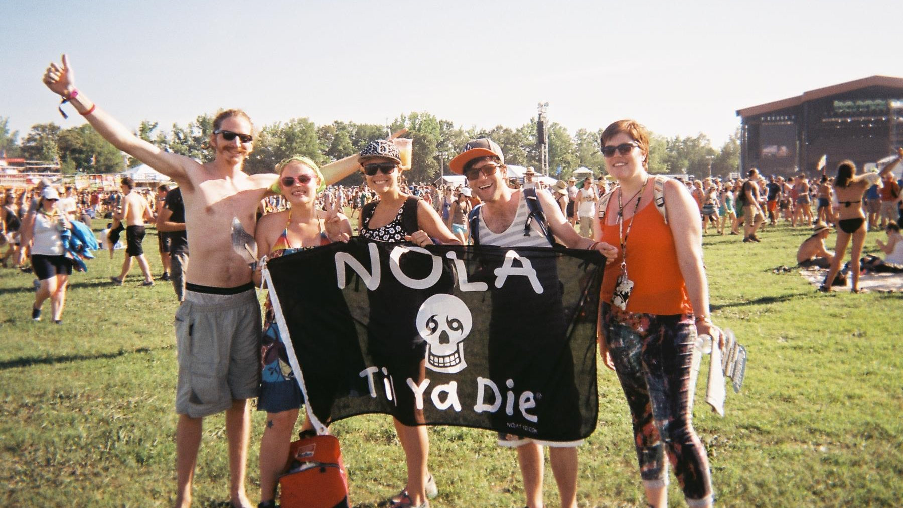 Group of friends at Bonaroo with NOLA Til Ya Die flag so more friends can find them in the crowd.