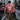 Firefighter walking on a city street with a fire truck in the background wearing Honor Til Ya Die with Nola Til Ya Die firefighter skull big on the back.