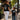 Woman and child walking on a sidewalk wearing black Honor Til Ya Die t-shirts with Nola Til Ya Die skull and text designs.